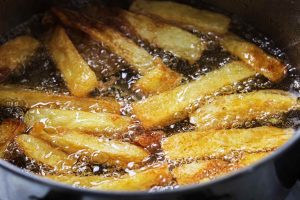 golden french fries cooking in oil
